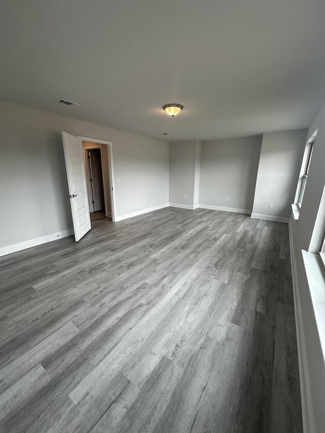 spare room with wood-type flooring