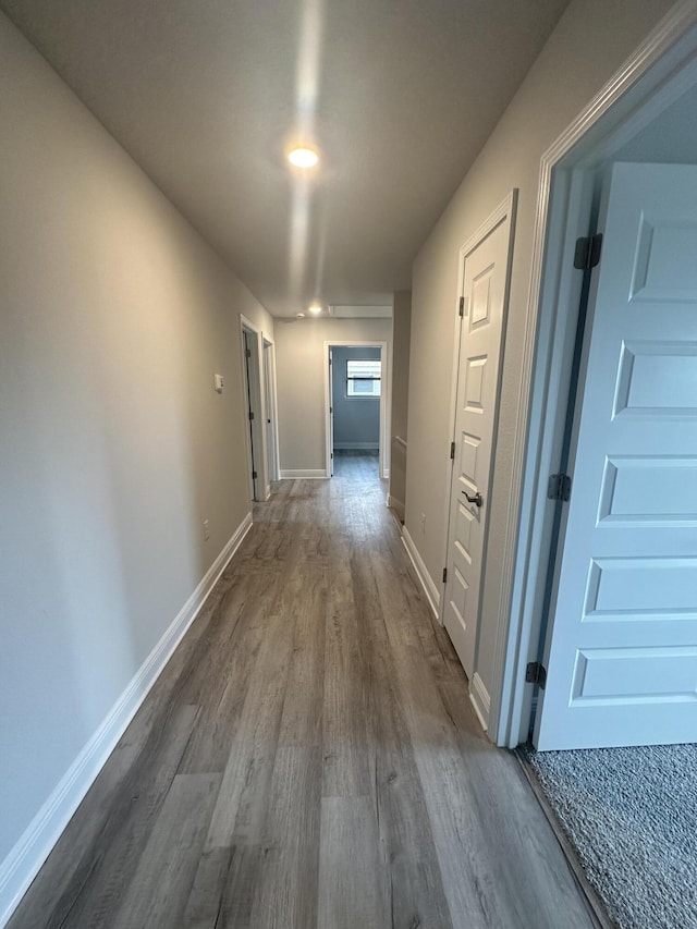 hallway with dark hardwood / wood-style flooring