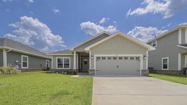 craftsman-style home featuring driveway, an attached garage, central AC, and a front yard