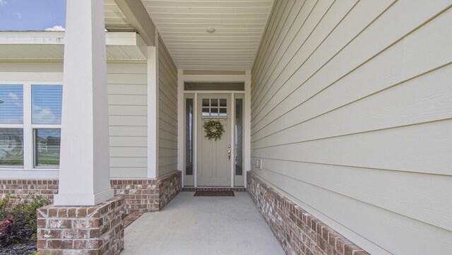 property entrance featuring brick siding