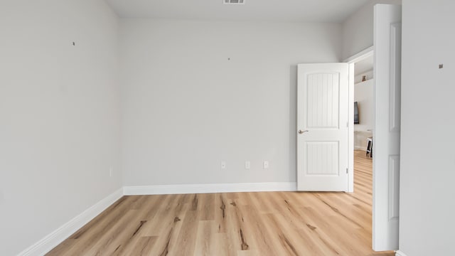 spare room with light wood-type flooring