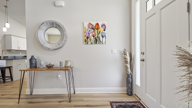 entryway featuring light wood finished floors and baseboards