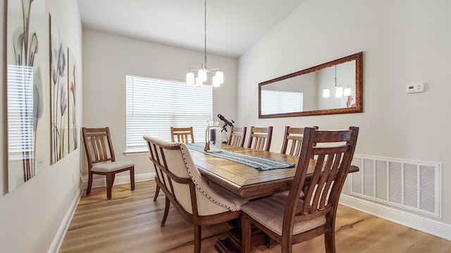 dining area featuring an inviting chandelier and light wood-type flooring