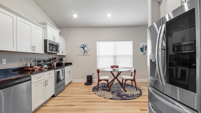 kitchen featuring appliances with stainless steel finishes, light hardwood / wood-style flooring, and white cabinets