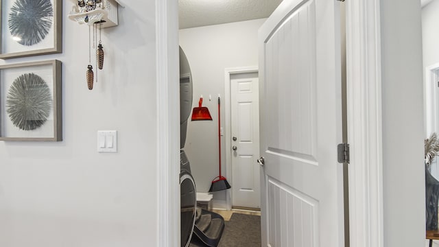 hall featuring arched walkways and a textured ceiling