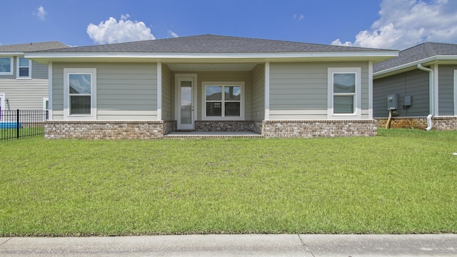 exterior space with a yard, brick siding, and fence