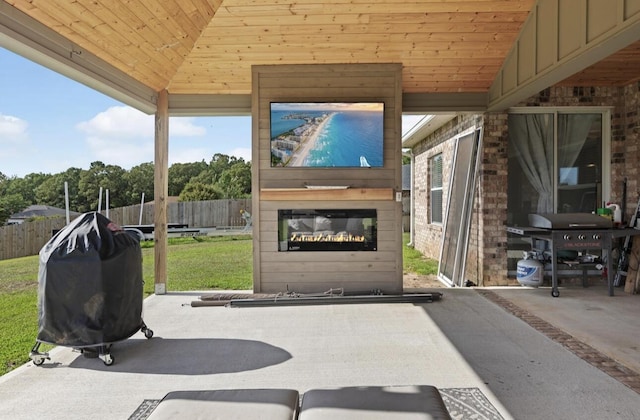 view of patio with grilling area and a fireplace