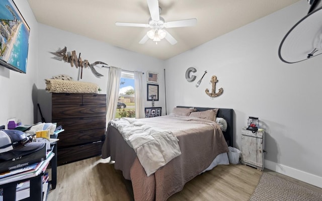 bedroom with ceiling fan and light hardwood / wood-style floors