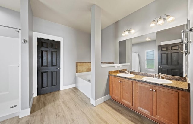 bathroom featuring vanity, shower with separate bathtub, and hardwood / wood-style floors