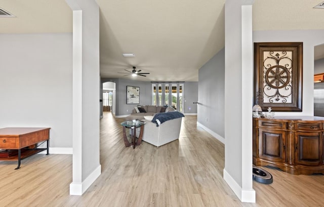 interior space with ceiling fan and light hardwood / wood-style flooring