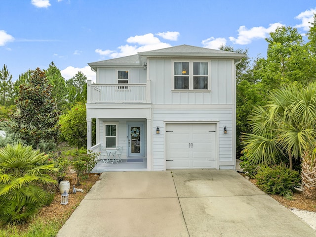 view of front of home with a balcony and a garage