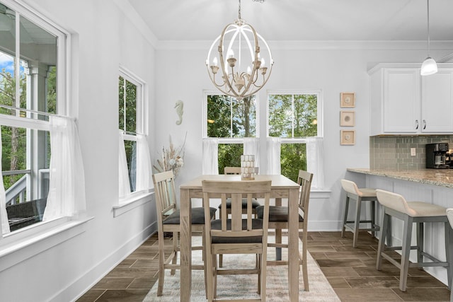 dining room with ornamental molding, a notable chandelier, a wealth of natural light, and dark wood-type flooring