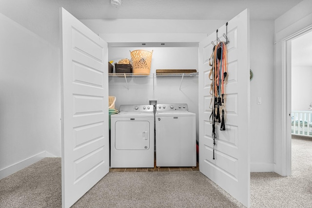 laundry room featuring washing machine and dryer and light carpet