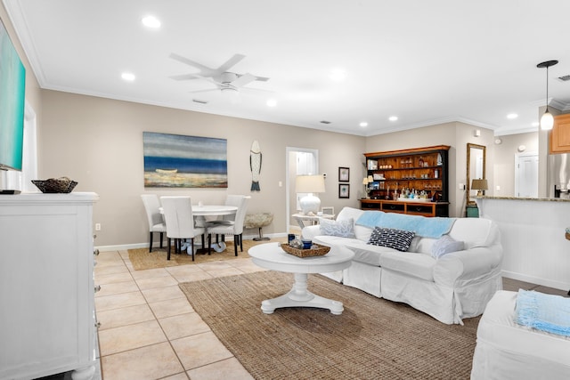 living room with ceiling fan, crown molding, and light tile patterned floors