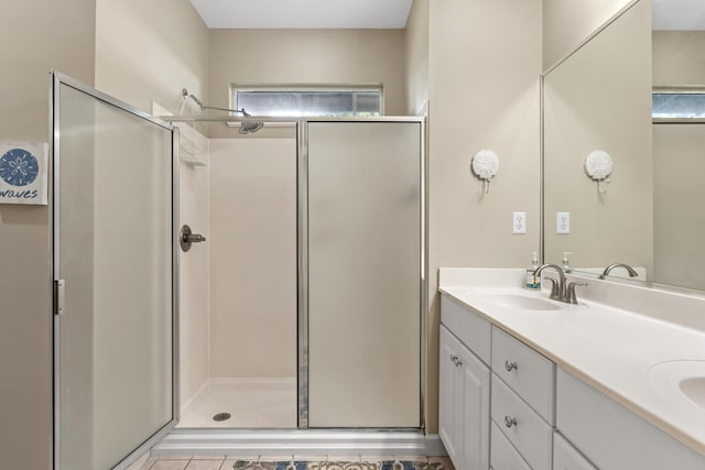 bathroom with a shower with door and vanity