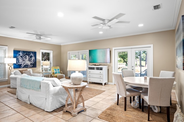 living room with ceiling fan, light tile patterned floors, crown molding, and french doors