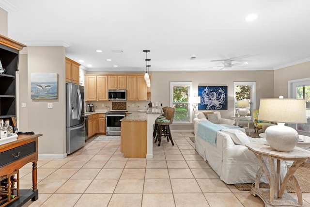 kitchen featuring crown molding, ceiling fan, decorative light fixtures, light stone counters, and stainless steel appliances