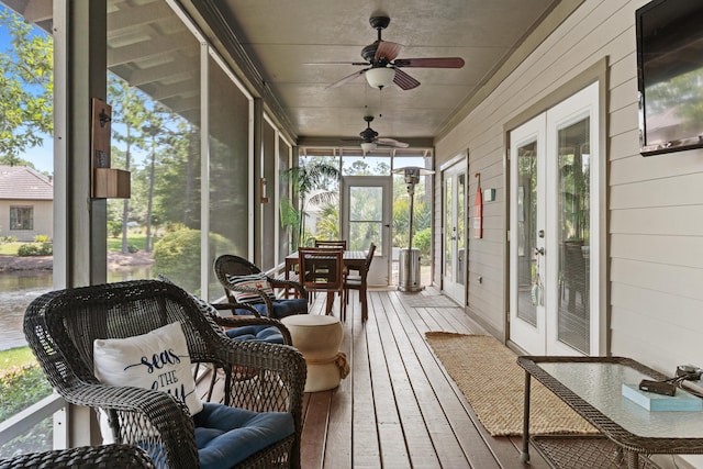 sunroom / solarium featuring ceiling fan