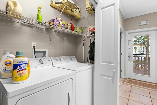 laundry room with independent washer and dryer, light tile patterned floors, and crown molding