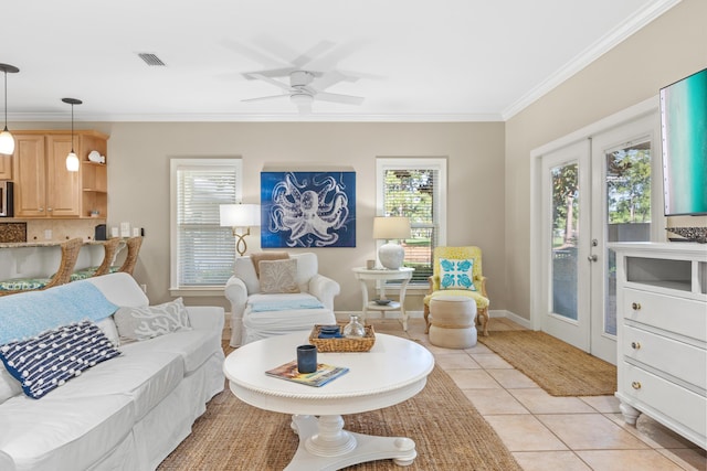 tiled living room with ceiling fan, french doors, and ornamental molding