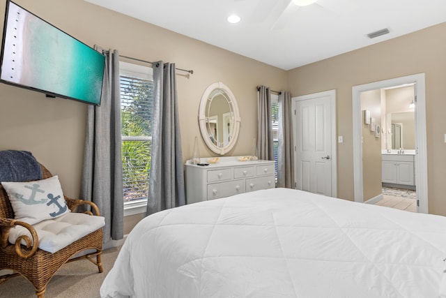 bedroom featuring ceiling fan and connected bathroom