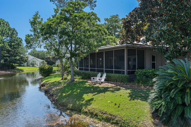 view of yard with a water view and a sunroom