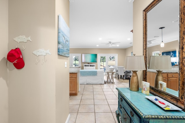 corridor featuring french doors, light tile patterned floors, and ornamental molding