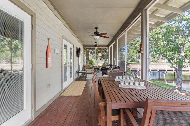 unfurnished sunroom featuring ceiling fan