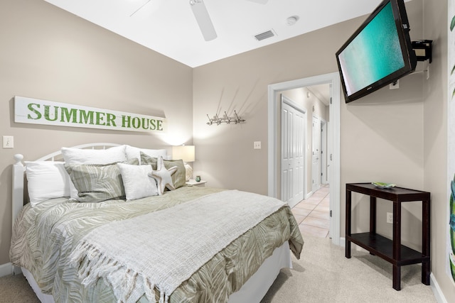 carpeted bedroom featuring a closet and ceiling fan