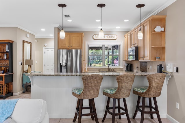 kitchen featuring kitchen peninsula, light stone countertops, stainless steel appliances, and a breakfast bar