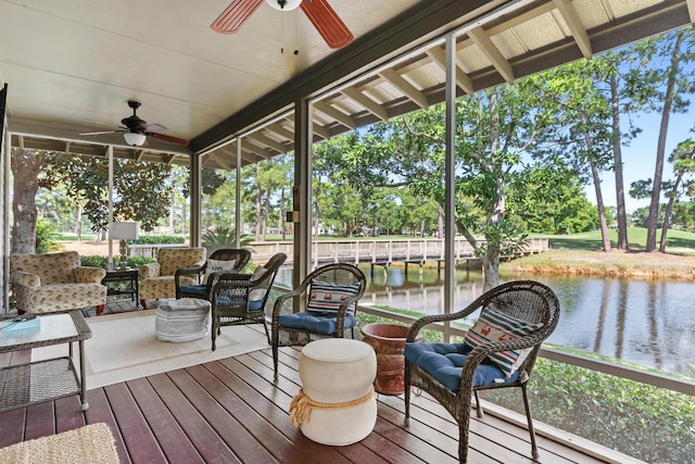 sunroom / solarium featuring ceiling fan, a water view, and a wealth of natural light