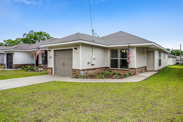 view of front of home with a front yard and a garage