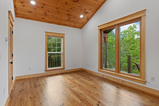 unfurnished room with vaulted ceiling, plenty of natural light, light hardwood / wood-style flooring, and wood ceiling