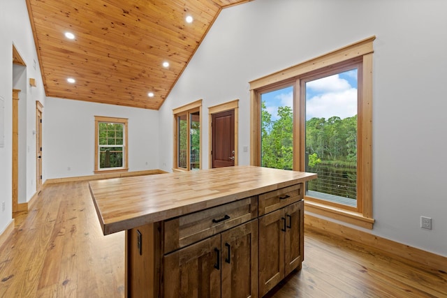 kitchen featuring wooden ceiling, butcher block countertops, a kitchen island, and light hardwood / wood-style flooring