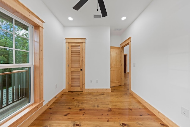 hallway with light hardwood / wood-style floors