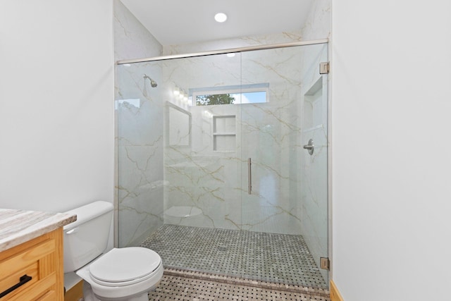 bathroom with vanity, toilet, and walk in shower