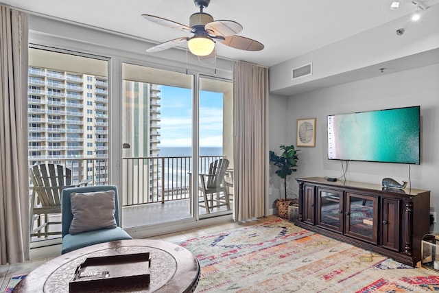 tiled living room with ceiling fan