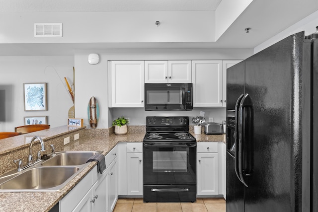 kitchen featuring black appliances, white cabinets, light tile patterned flooring, and sink