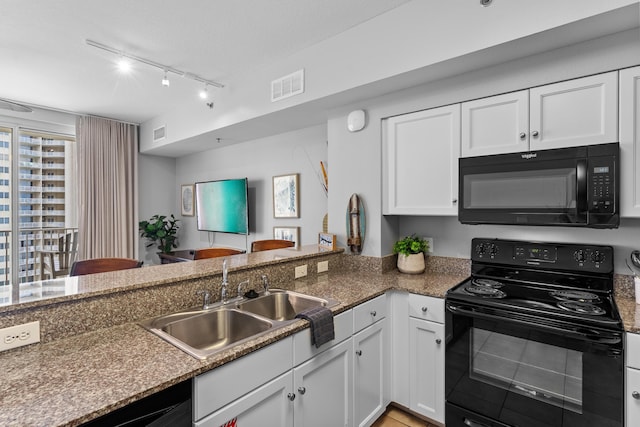 kitchen featuring sink, white cabinetry, kitchen peninsula, track lighting, and black appliances