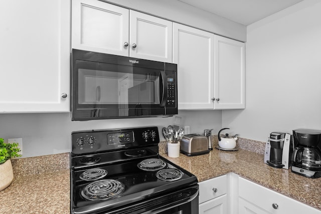 kitchen with black appliances and white cabinets