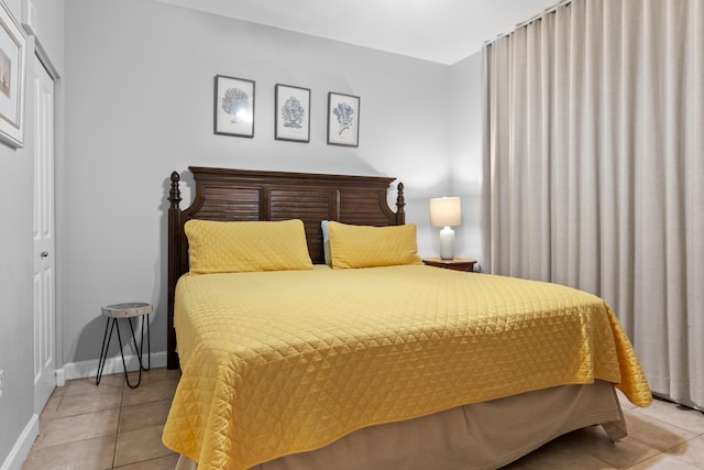 tiled bedroom featuring a closet