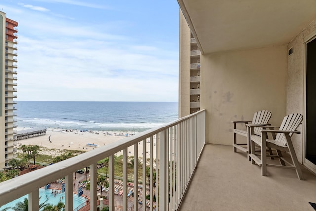 balcony featuring a beach view and a water view