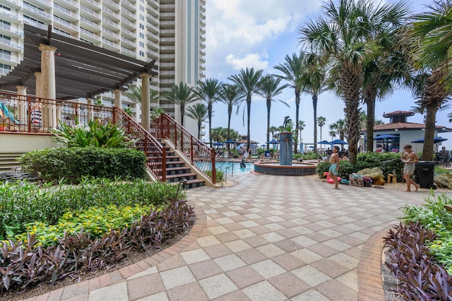 view of home's community featuring a swimming pool, a pergola, and a patio area