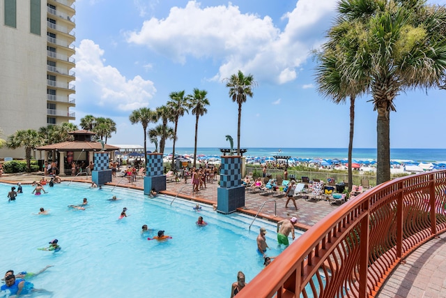 view of pool with a gazebo and a water view