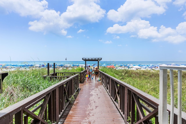 surrounding community with a beach view and a water view