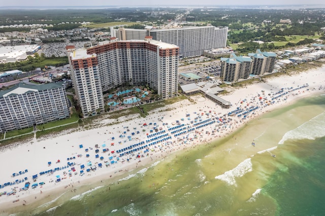 drone / aerial view featuring a beach view and a water view