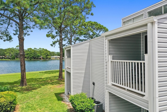 view of home's exterior with a water view, central air condition unit, and a lawn