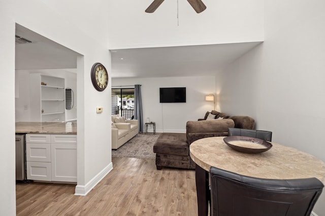 living room featuring ceiling fan and light hardwood / wood-style flooring