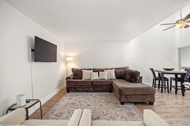 living room featuring hardwood / wood-style flooring and ceiling fan