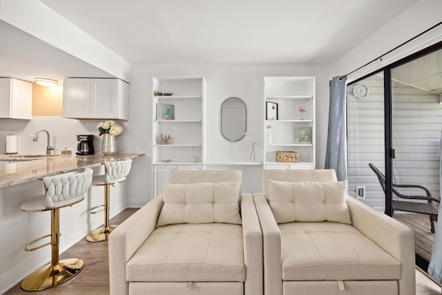 living room featuring sink and hardwood / wood-style floors